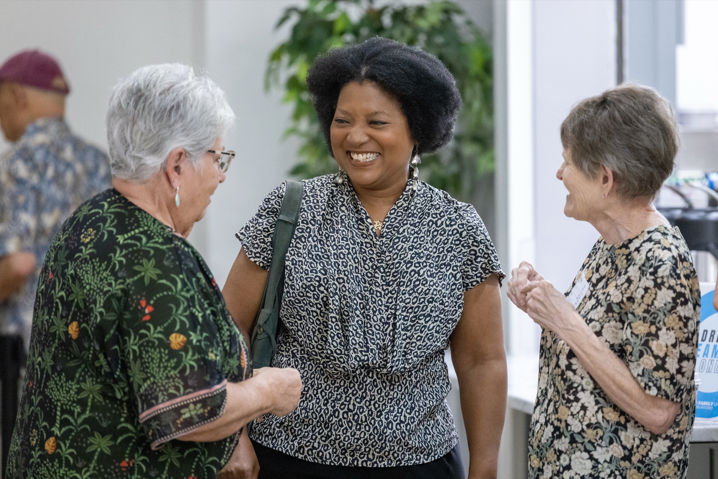Three women laughing together in the lobby