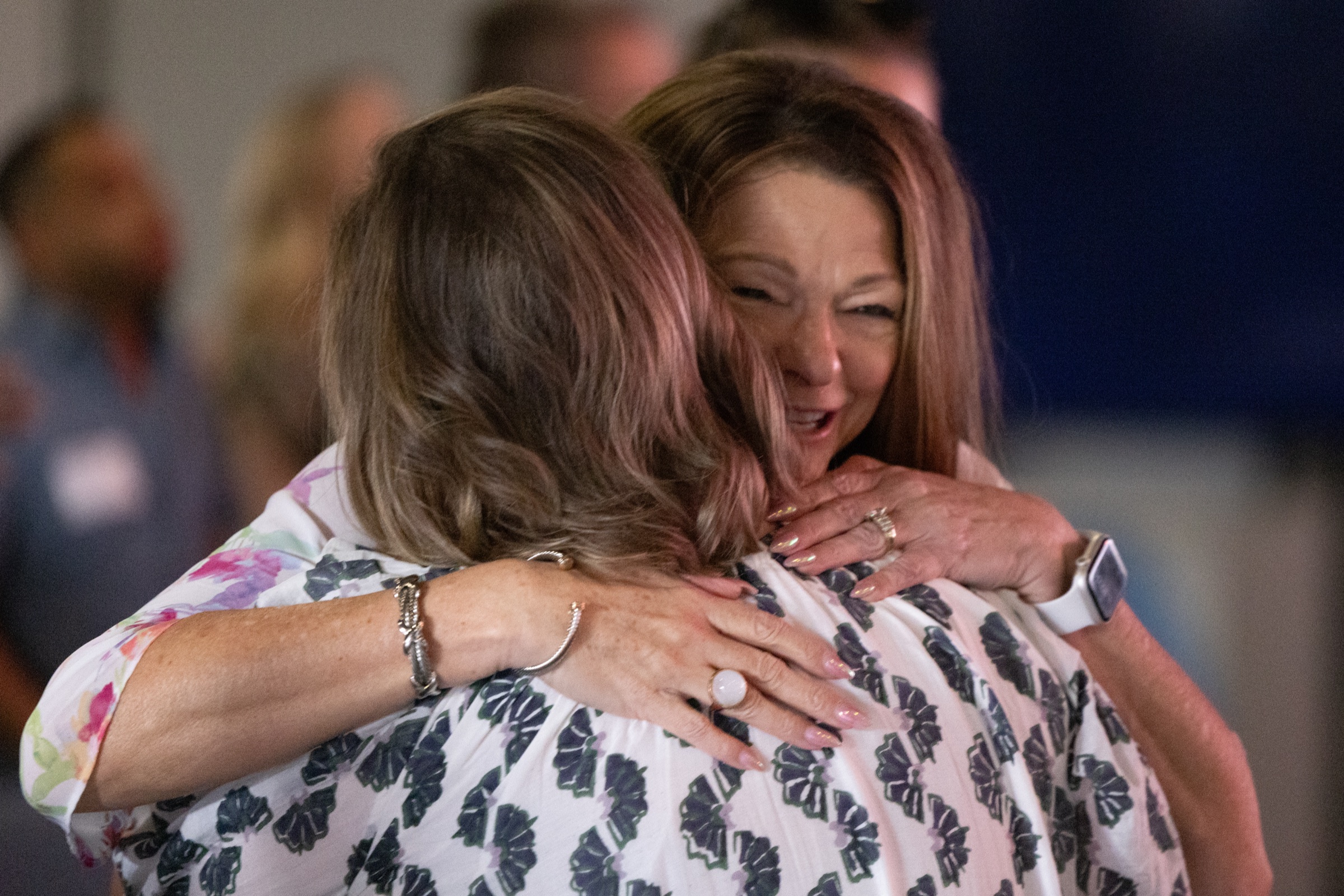 Two friends embracing after a service