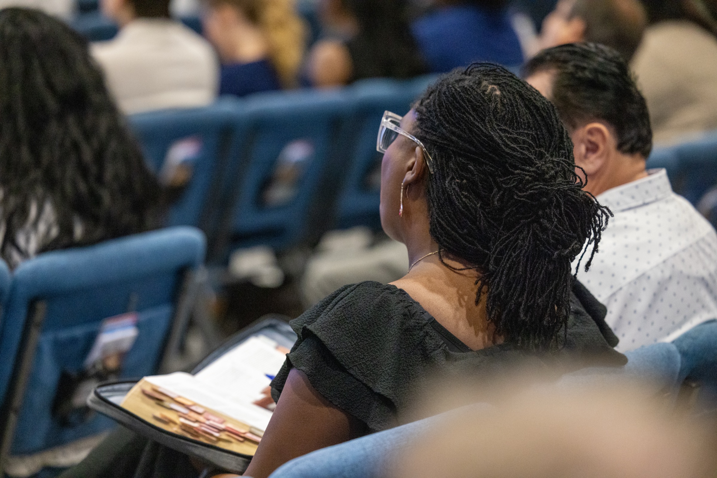 A woman taking notes during a Growth Track session